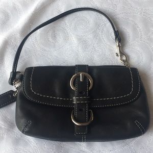 Coach wristlet with front buckle.